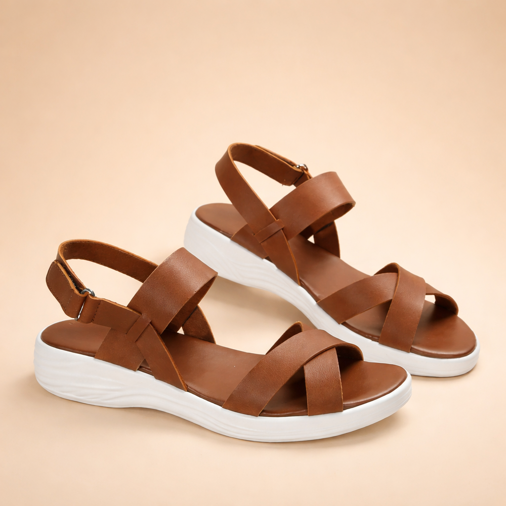 elegant-womens-brown-strappy-sandals-model-posed-studio-shot-caramel-sand-background.png