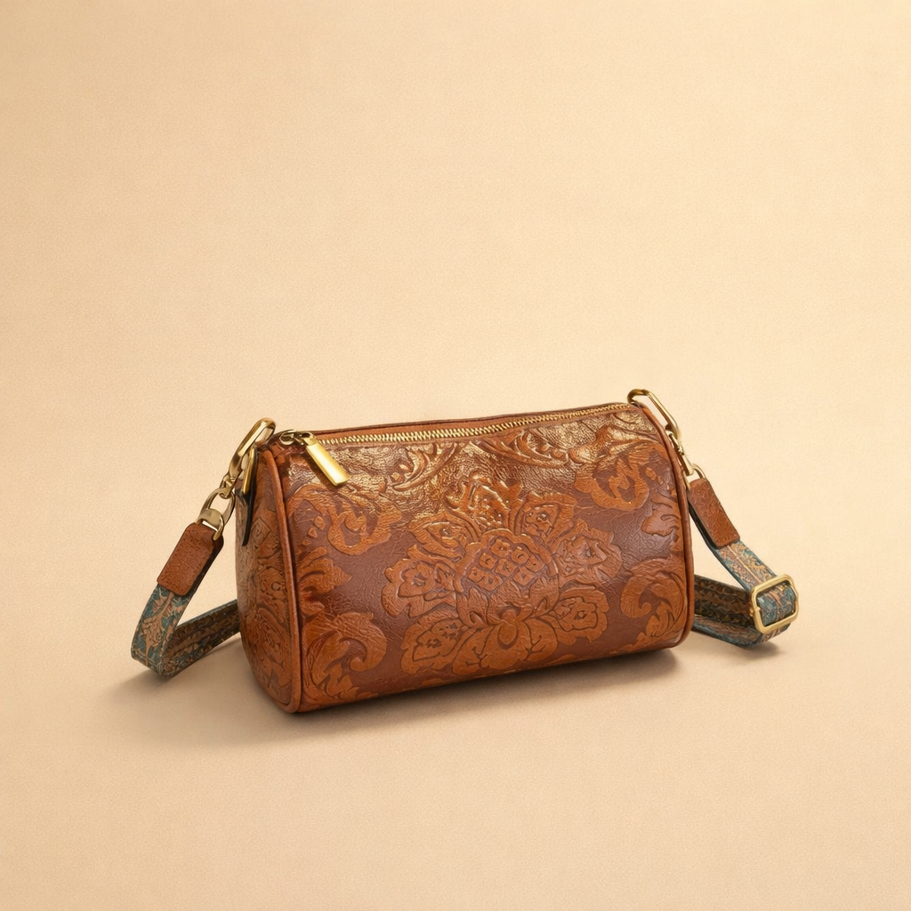 woman-holding-brown-embossed-leather-cylinder-handbag-studio-fashion-shot.png